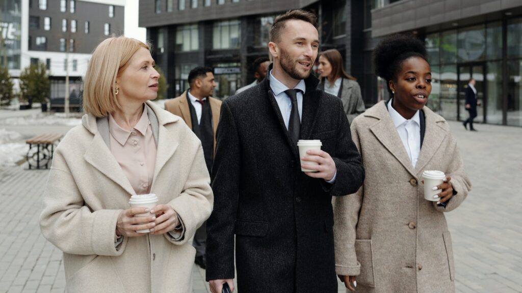 coworkers walking and taking a coffee break